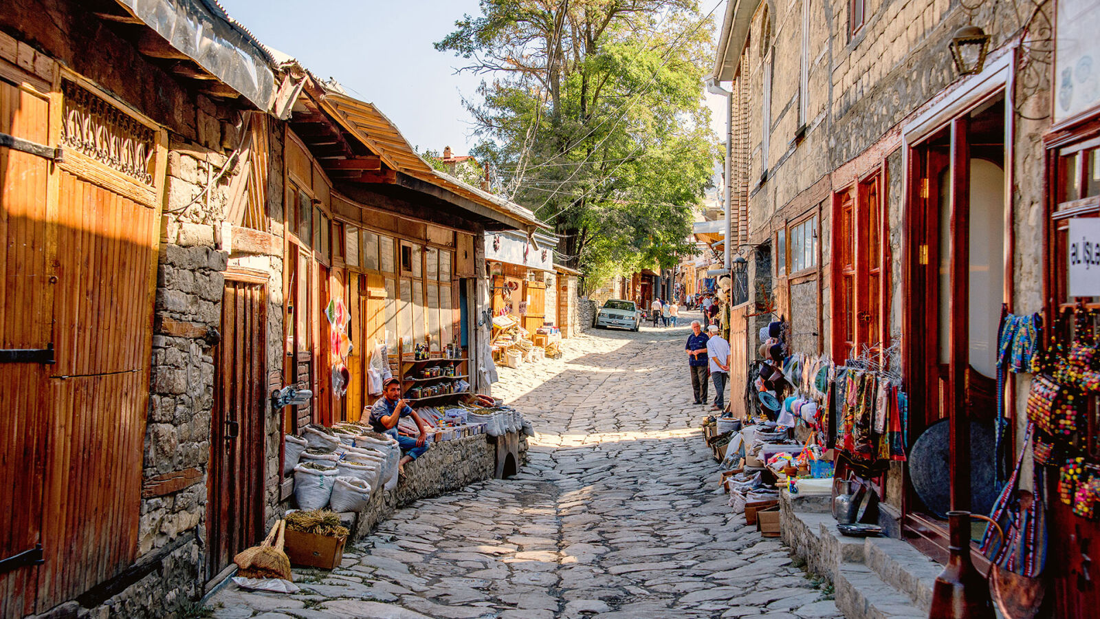 Cobblestone lane of Lahij village with copper workshop open to the street — Azerbaijan photography tour